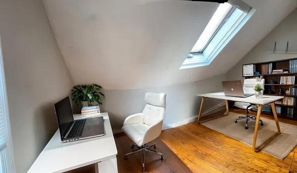 a view of a workspace with furniture and a potted plant
