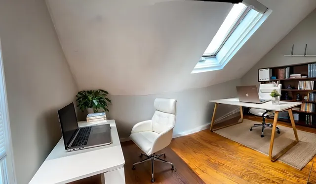 a view of a workspace with furniture and a potted plant