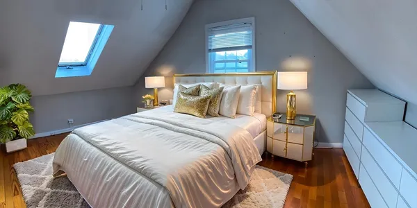 a bedroom with a bed and a potted plant