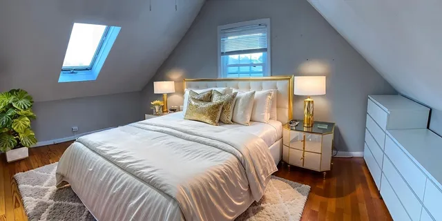 a bedroom with a bed and a potted plant