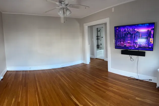 a view of a room with wooden floor and cabinet