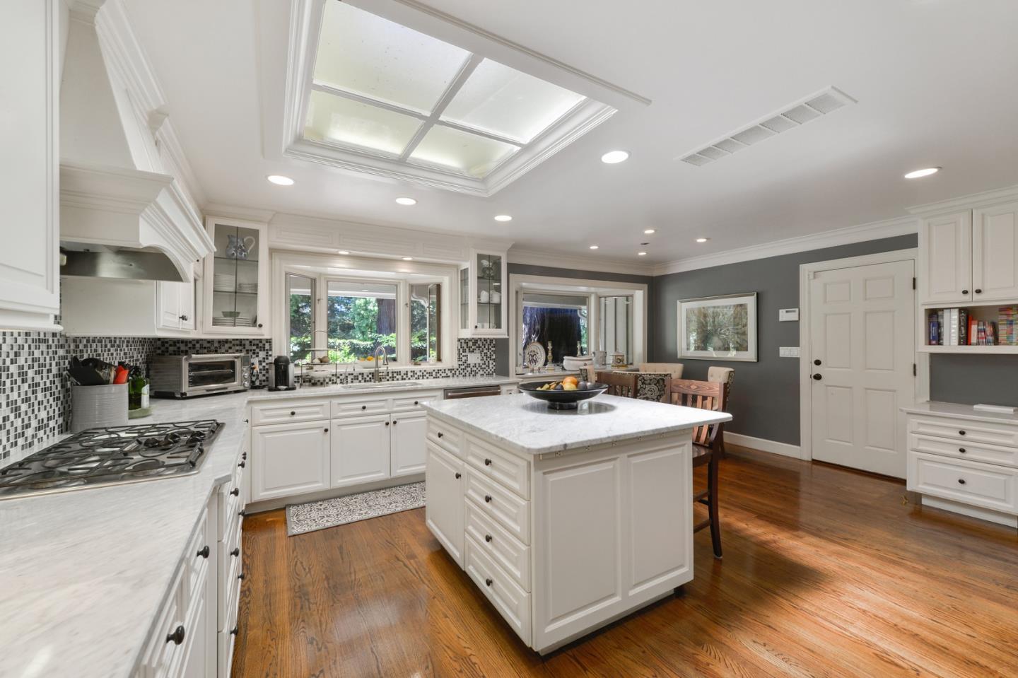 261 Atherton Avenue Atherton, CA 94027 - Photo 13 of 49 a kitchen with stainless steel appliances kitchen island granite countertop a sink a stove and a wooden floors