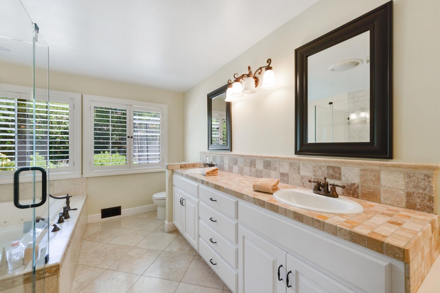 261 Atherton Avenue Atherton, CA 94027 - Photo 18 of 49 a spacious bathroom with a double vanity sink a mirror and a bathtub