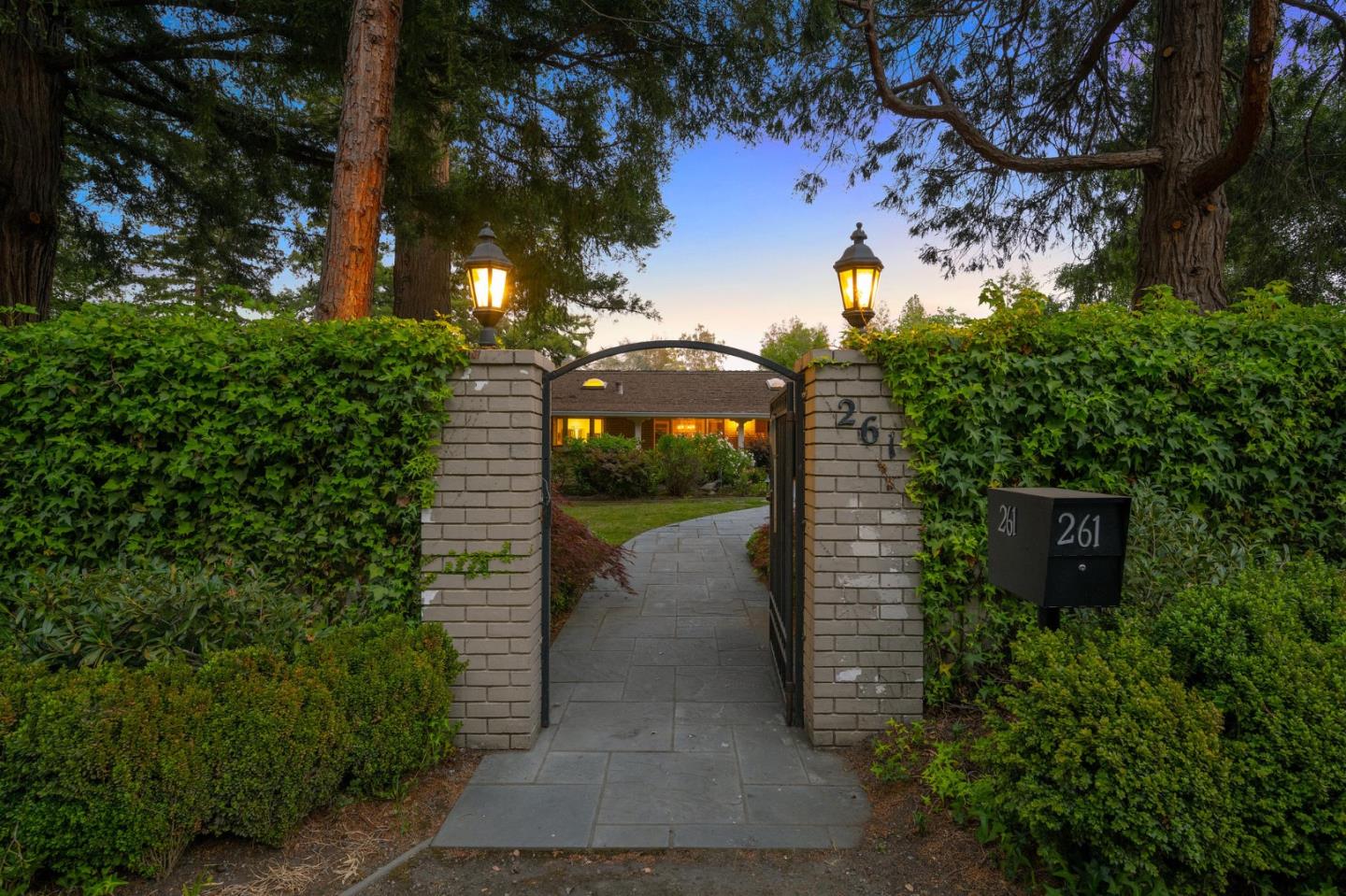 261 Atherton Avenue Atherton, CA 94027 - Photo 2 of 49 a view of a garden with a bench