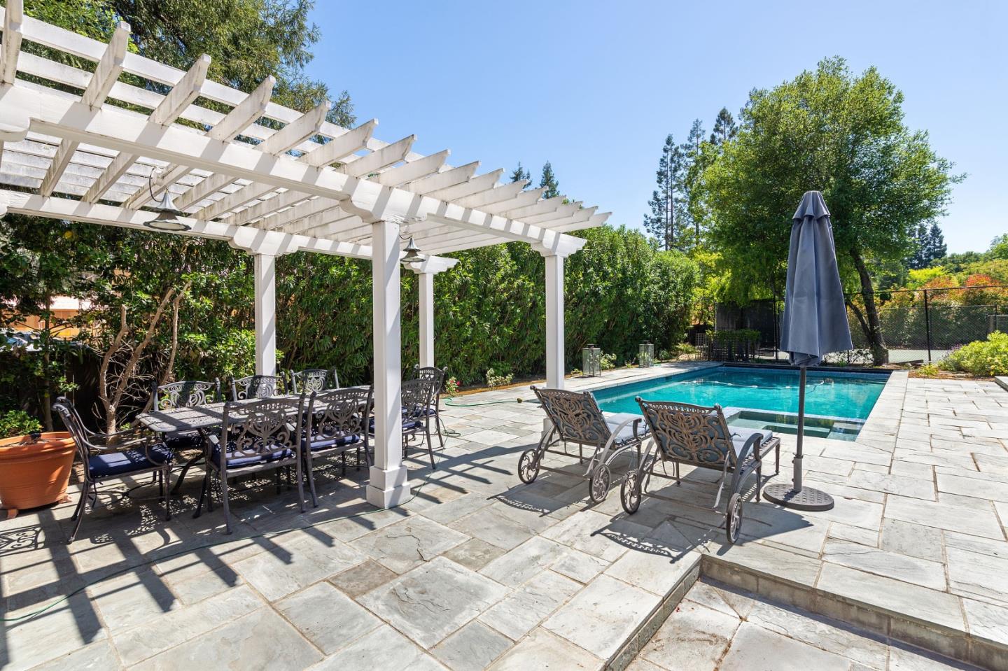261 Atherton Avenue Atherton, CA 94027 - Photo 30 of 49 a view of a patio with a dining table and chairs with wooden floor and fence