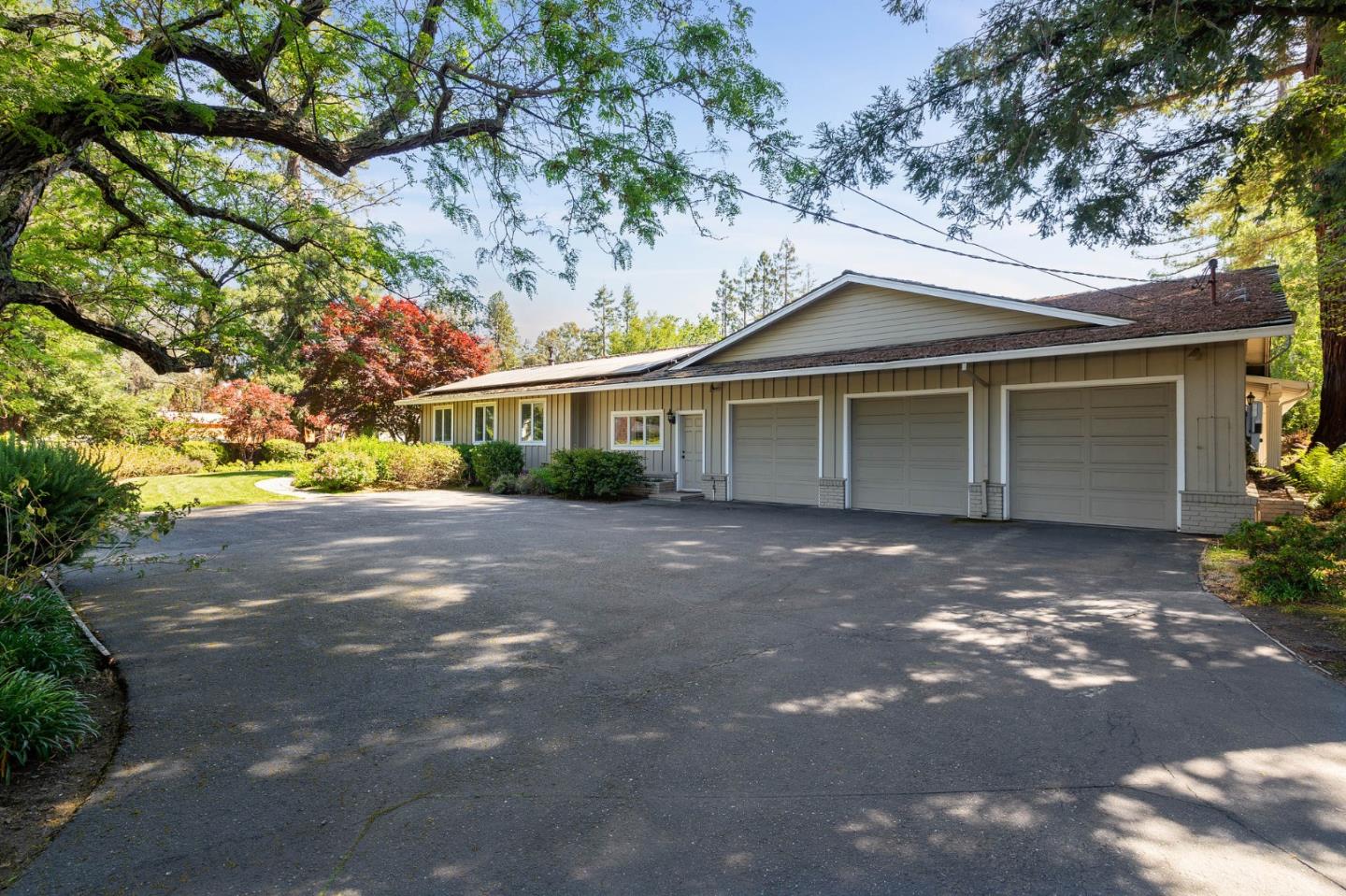 261 Atherton Avenue Atherton, CA 94027 - Photo 36 of 49 a front view of a house with a yard and garage