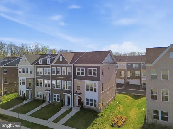a view of a big house with a big yard and large trees
