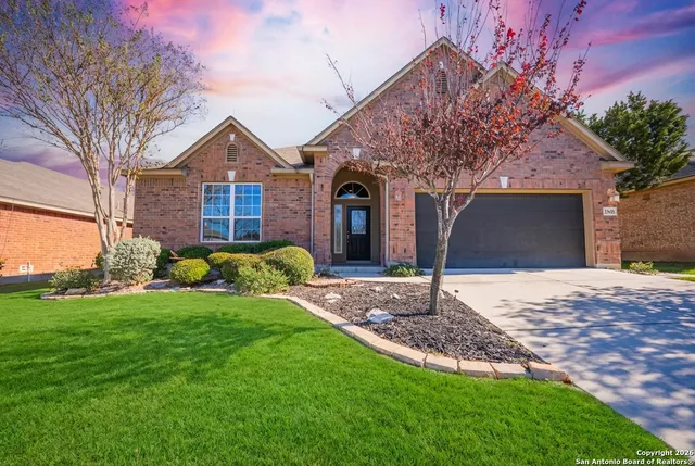 a front view of a house with a yard and garage