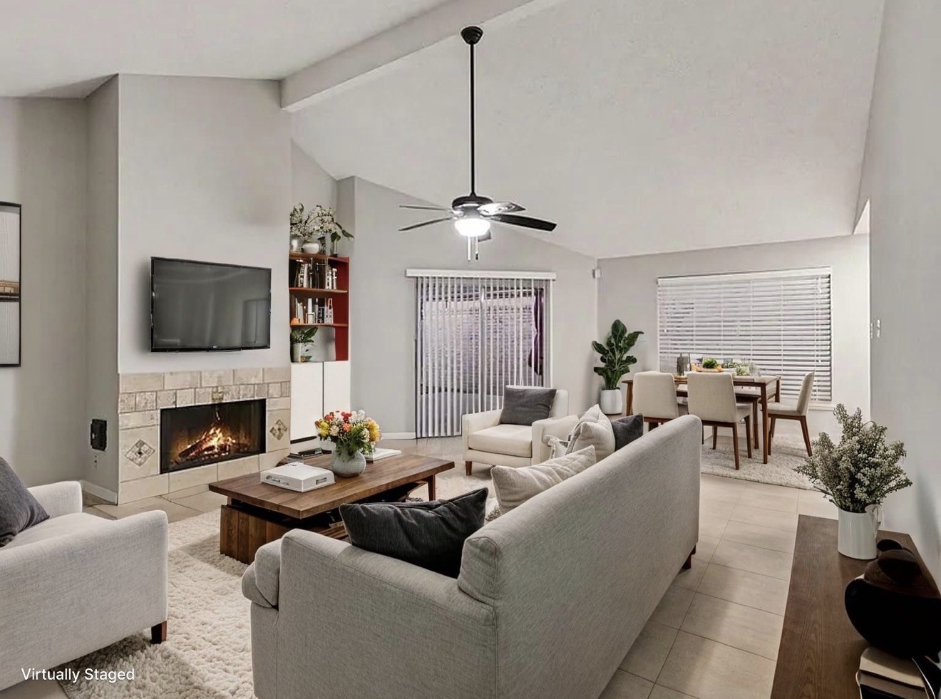 a living room with furniture a fireplace and a chandelier