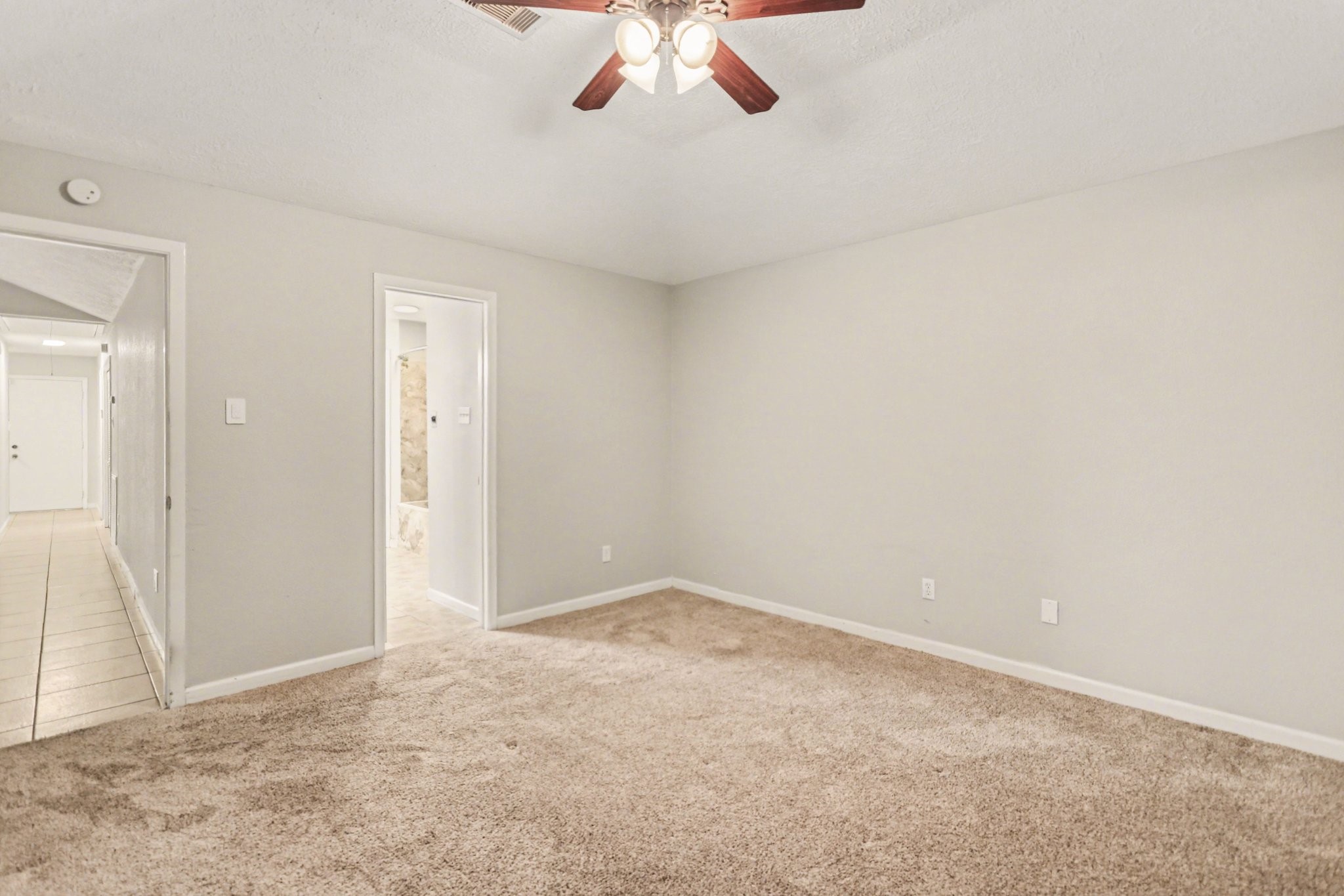 2450 Blackridge Road Houston, TX 77067 - Photo 12 of 21 an empty room with a chandelier fan