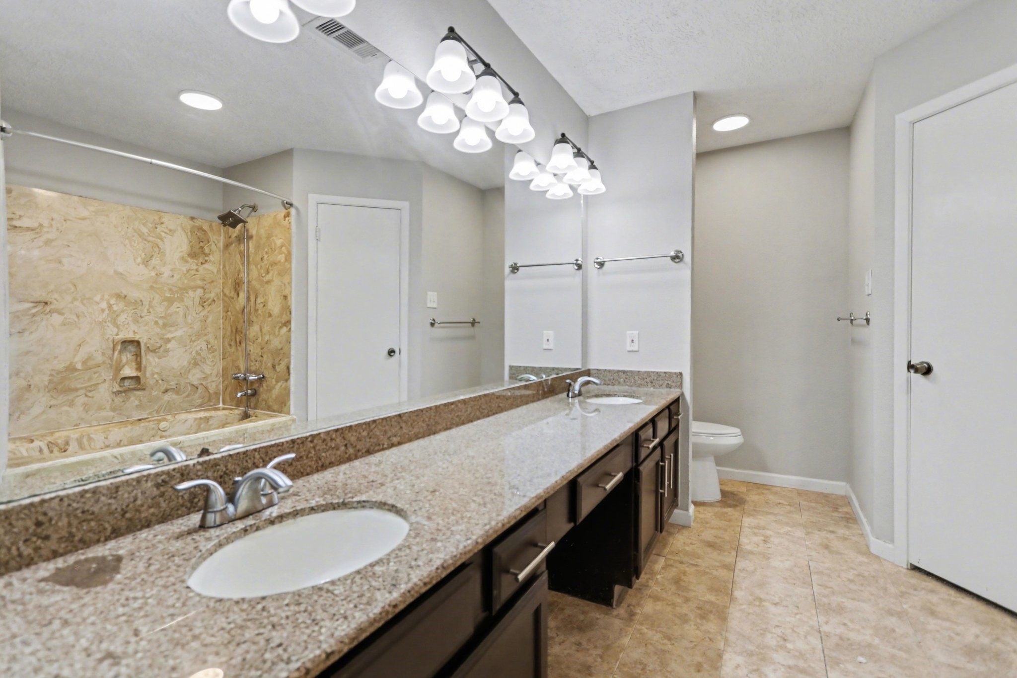 2450 Blackridge Road Houston, TX 77067 - Photo 13 of 21 a bathroom with a granite countertop sink a light fixture and a mirror