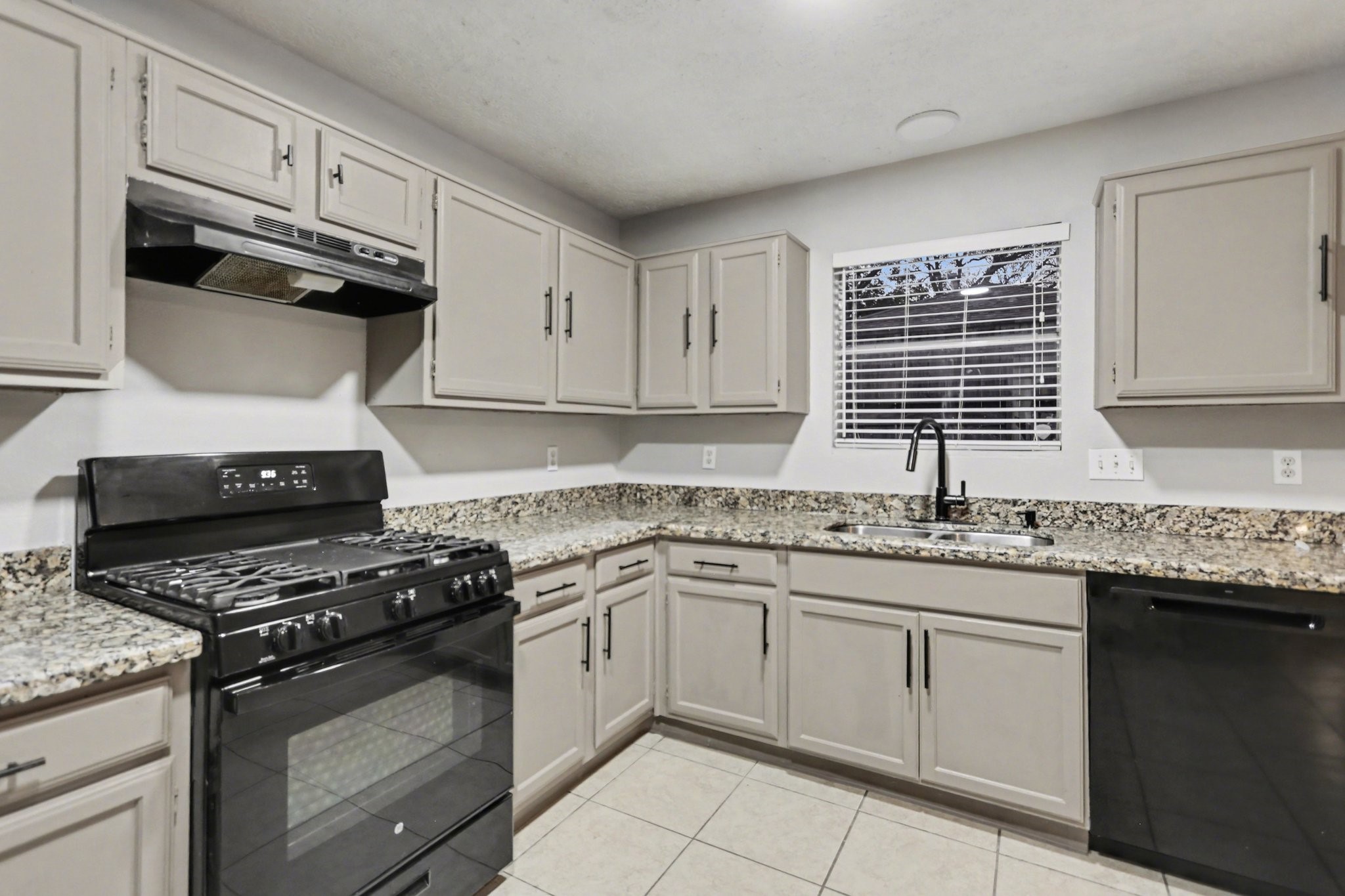 2450 Blackridge Road Houston, TX 77067 - Photo 8 of 21 a kitchen with granite countertop stainless steel appliances a sink stove and cabinets