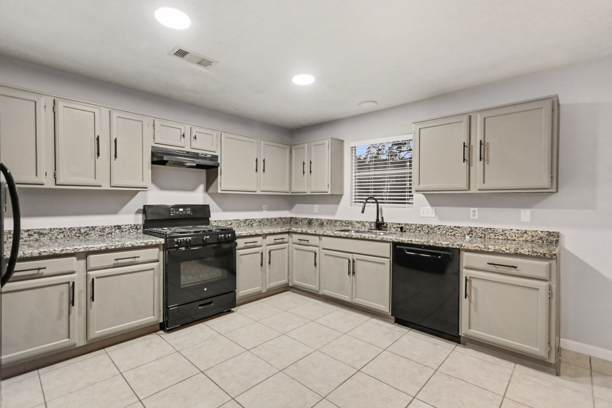 2450 Blackridge Road Houston, TX 77067 - Photo 9 of 21 a kitchen with granite countertop white cabinets and stainless steel appliances