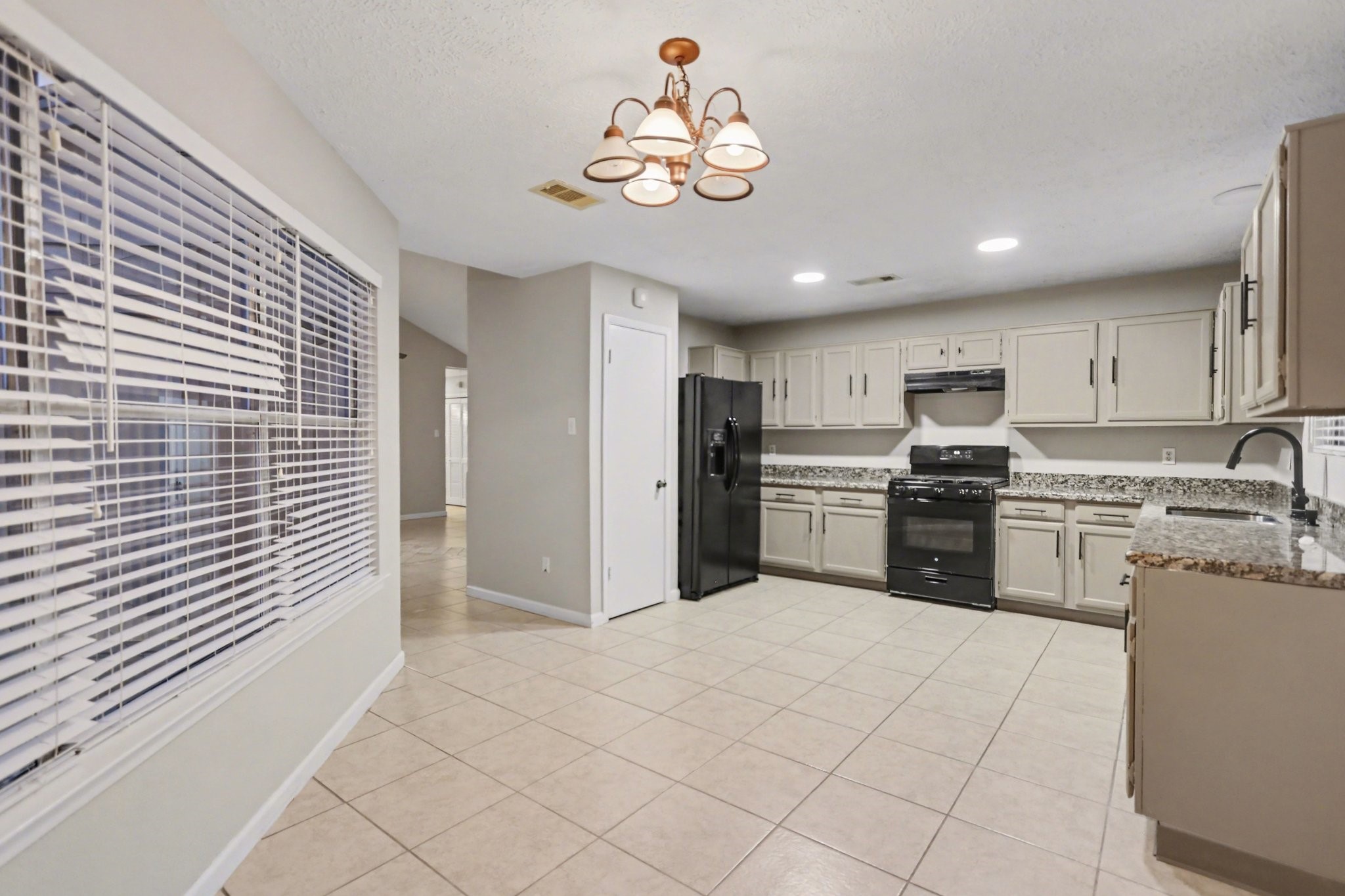 2450 Blackridge Road Houston, TX 77067 - Photo 10 of 21 a kitchen with stainless steel appliances kitchen island granite countertop a refrigerator and a sink