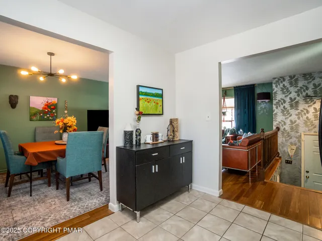a living room with furniture and a dining table