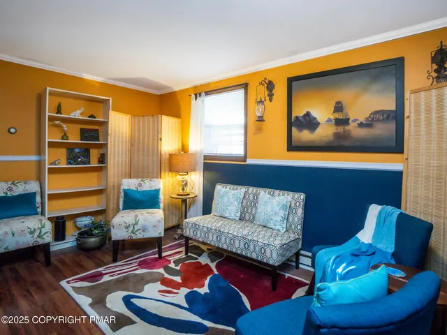a living room with furniture fireplace and rug