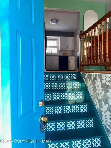 a view of kitchen with granite countertop lots of counter top space and a window