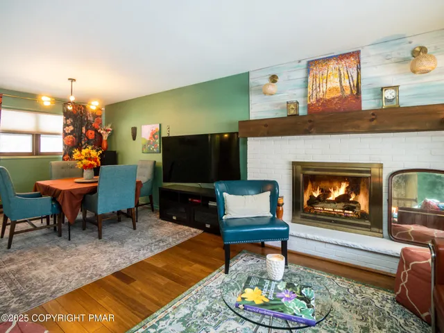 a living room with furniture a fireplace and a flat screen tv