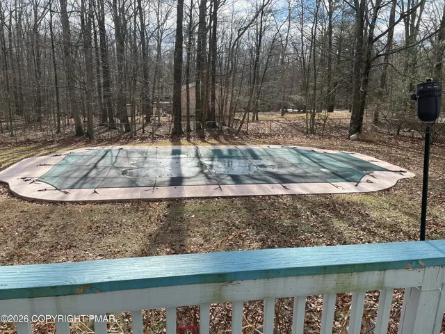 a view of a yard with wooden fence