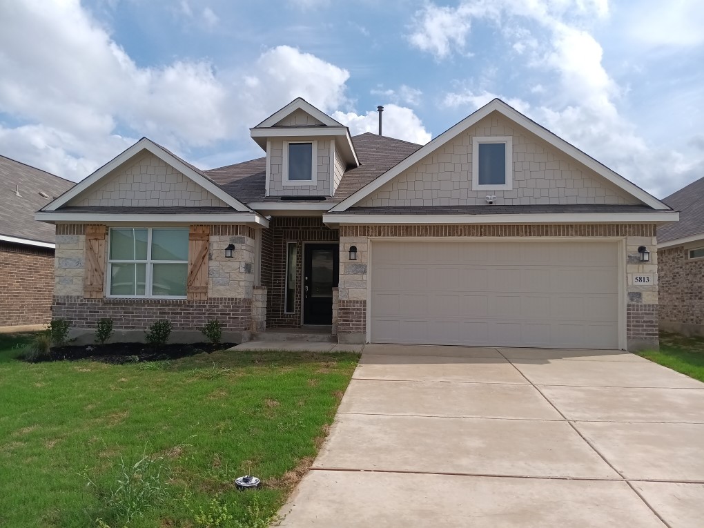 5813 Musquiz Ridge Seguin, TX 78155 - Photo 15 of 15 a front view of a house with a garden and plants