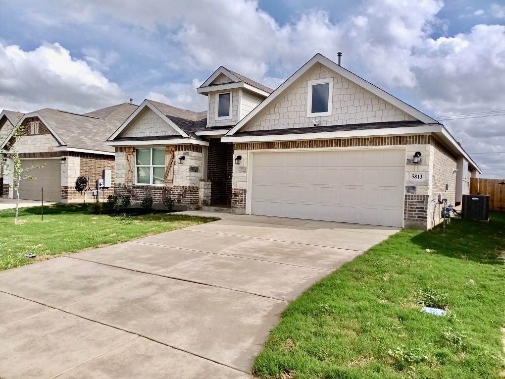 5813 Musquiz Ridge Seguin, TX 78155 - Photo 3 of 15 a front view of a house with a yard and garage