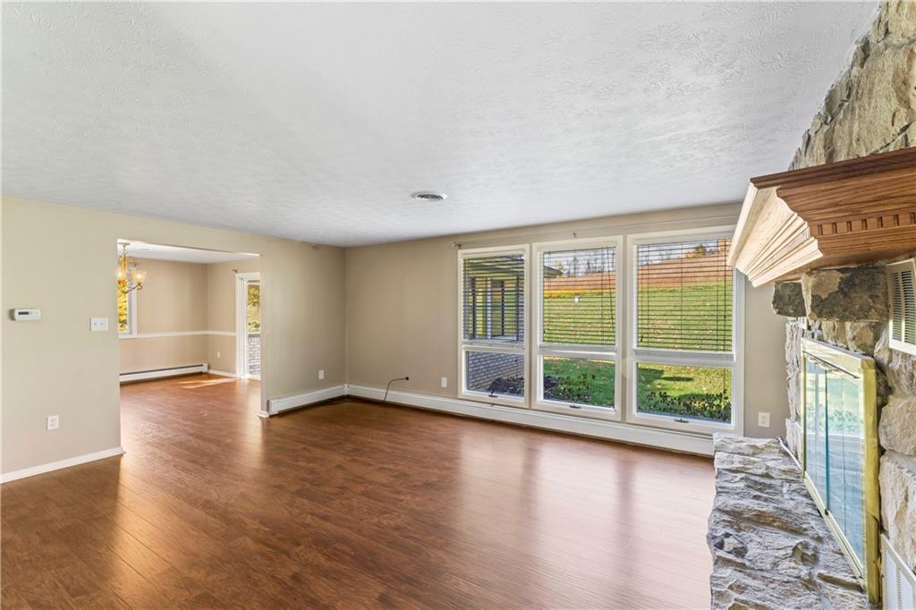 413 Pine Run Road Washington, PA 15301 - Photo 10 of 25 an empty room with wooden floor and windows