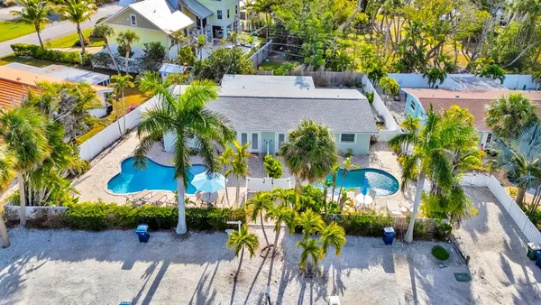an aerial view of a house with a yard and garden