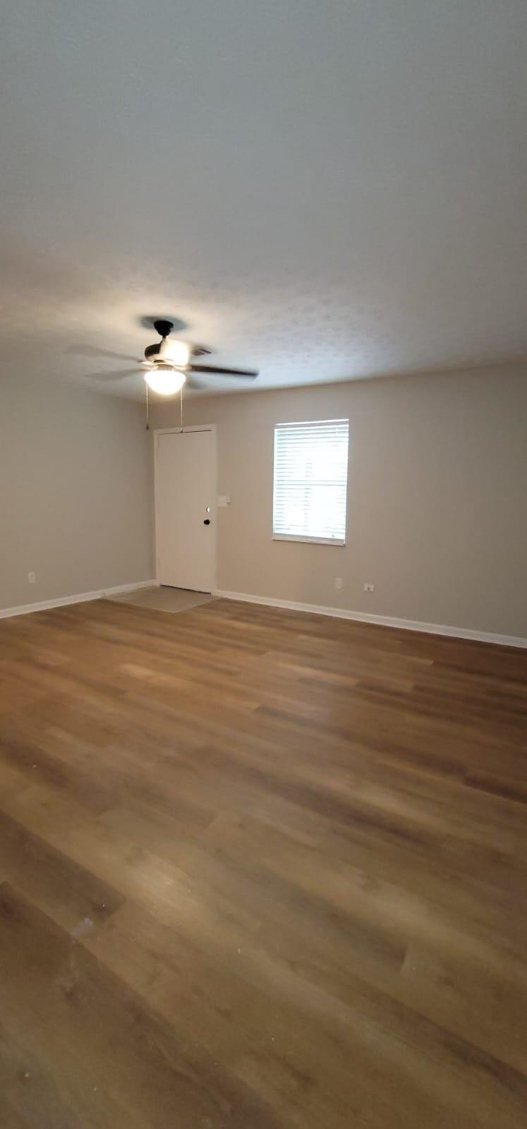 2888 Parrott Avenue Northwest, Unit A Atlanta, GA 30318 - Photo 14 of 21 a view of an empty room with wooden floor and window