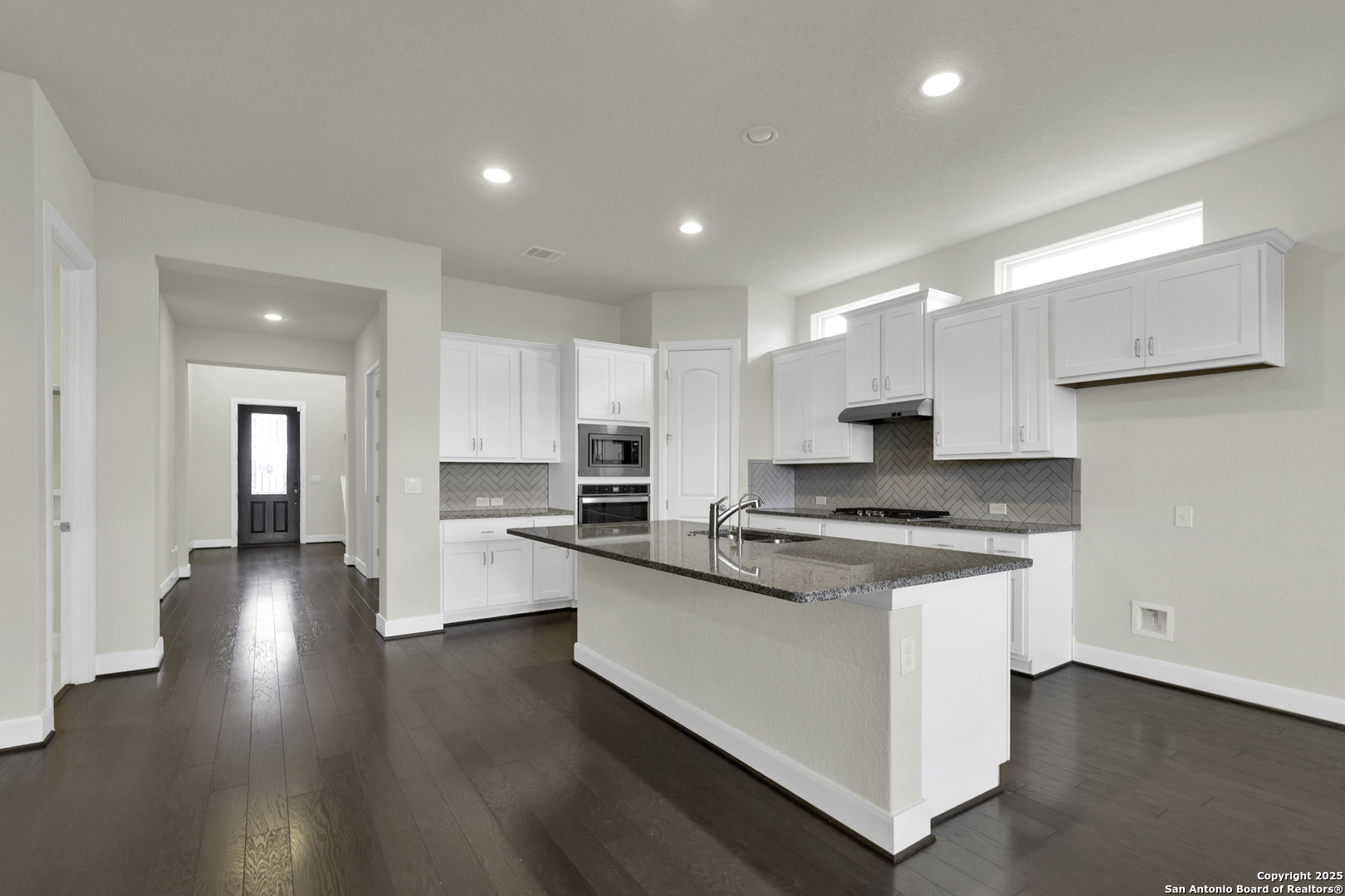 945 Foxbrook Way Cibolo, TX 78108 - Photo 6 of 20 a kitchen with stainless steel appliances stove a sink and a refrigerator