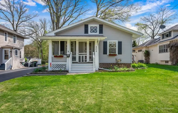 a view of a house with a yard and sitting area
