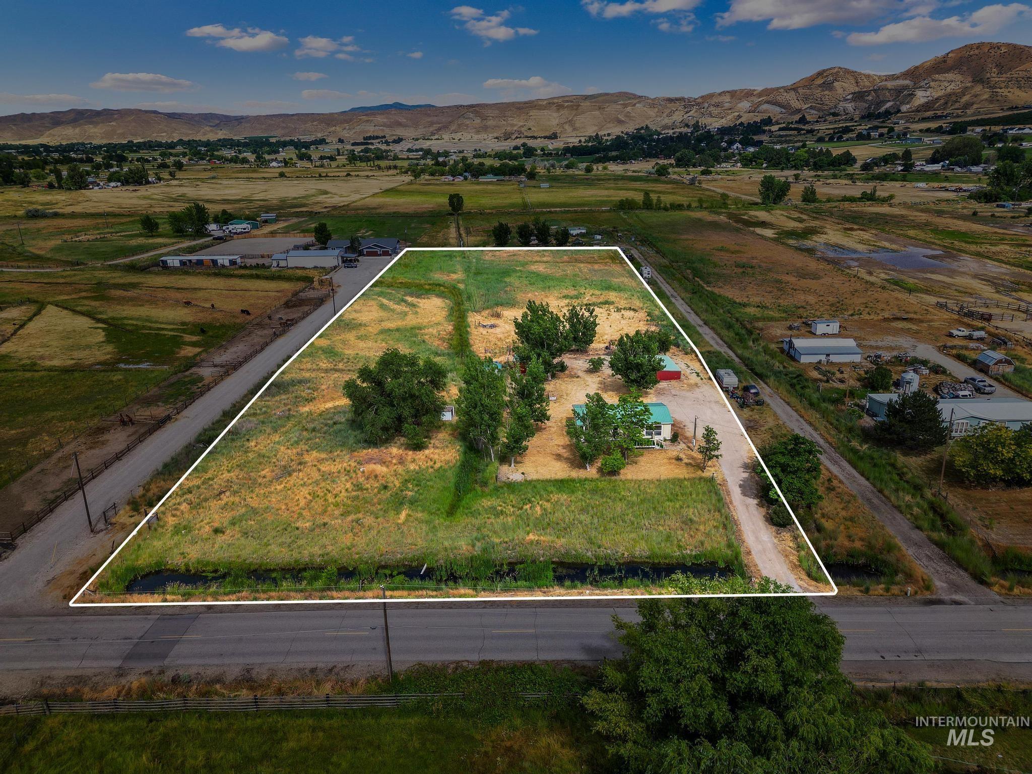 3680 South Mill Road Emmett, ID 83617 - Photo 31 of 38 Expansive rural lot featuring a single-story residence, multiple outbuildings, and mature trees