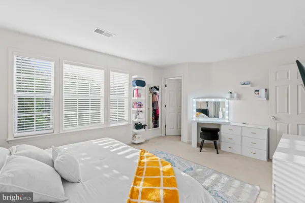 a spacious bedroom with a bed and a table