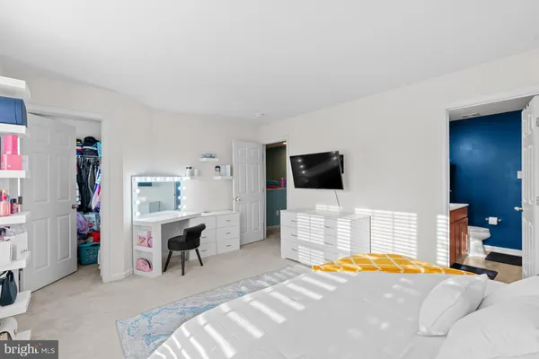 a bedroom with furniture and a flat screen tv