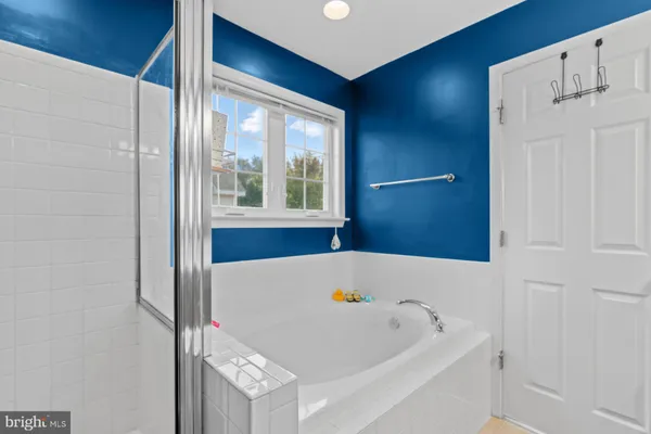 a bathroom with a tub and a shower