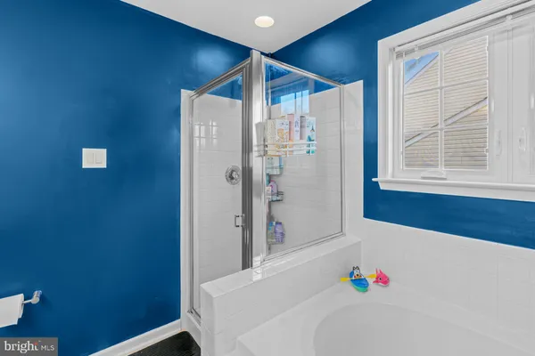 a bathroom with a bathtub and a shower