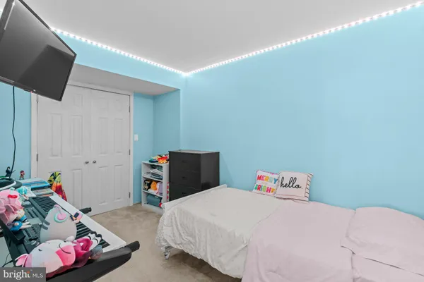 a bedroom with a bed and a tv
