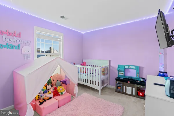a bedroom with furniture and a baby crib