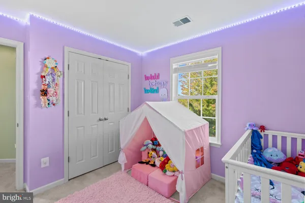 a living room with furniture and baby crib