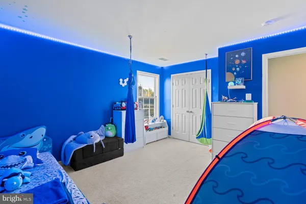 a bedroom with bed and window