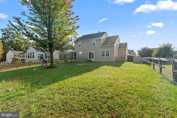 a view of house with backyard