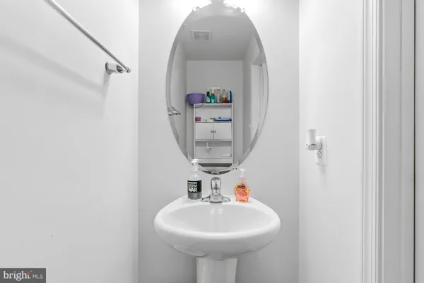 a bathroom with a sink a mirror and vanity
