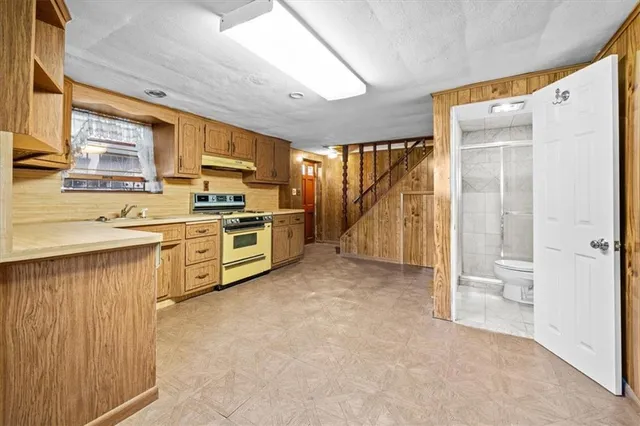 a kitchen with a stove a sink and a refrigerator
