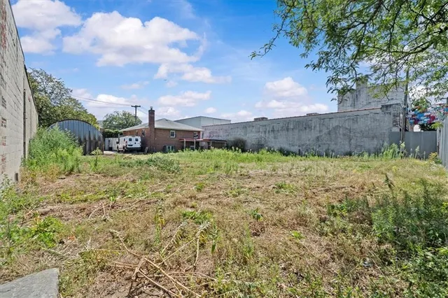 a view of a garden with a building in the background