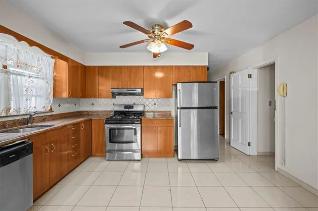 a kitchen with stainless steel appliances granite countertop a refrigerator oven a sink and dishwasher