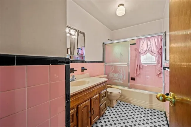 a bathroom with a sink a toilet a mirror and shower