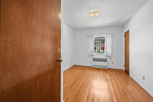 an empty room with a hardwood and front door