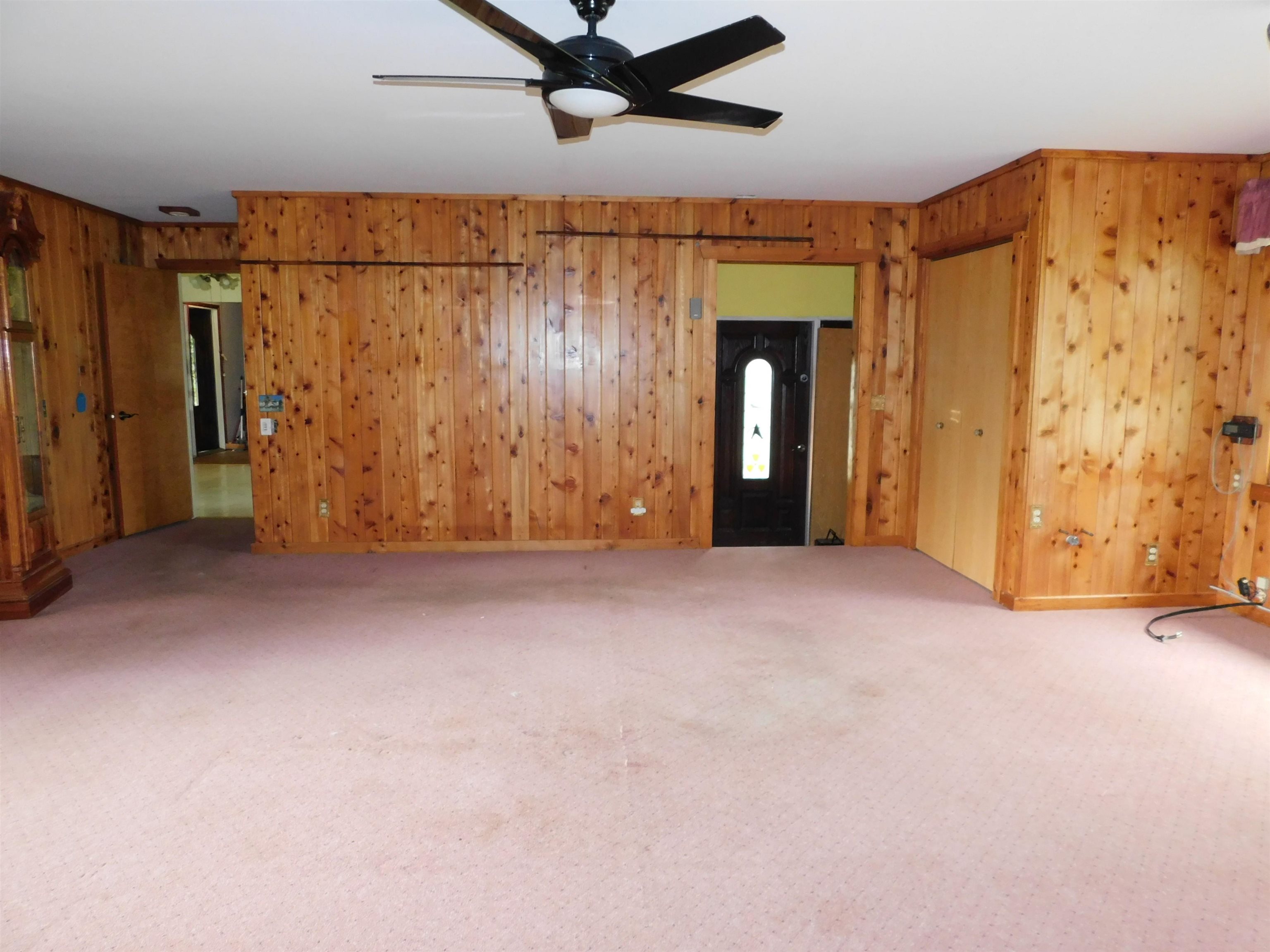 4036 County Rd A Superior, WI 54880 - Photo 13 of 52 Unfurnished living room featuring wooden walls, carpet, and ceiling fan