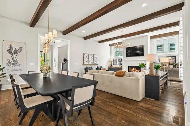 a work room with furniture a rug and a window