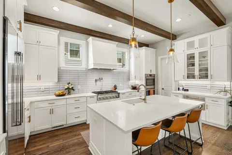 a view of a hallway with wooden floor and stairs