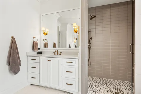 a bathroom with a sink a toilet and shower